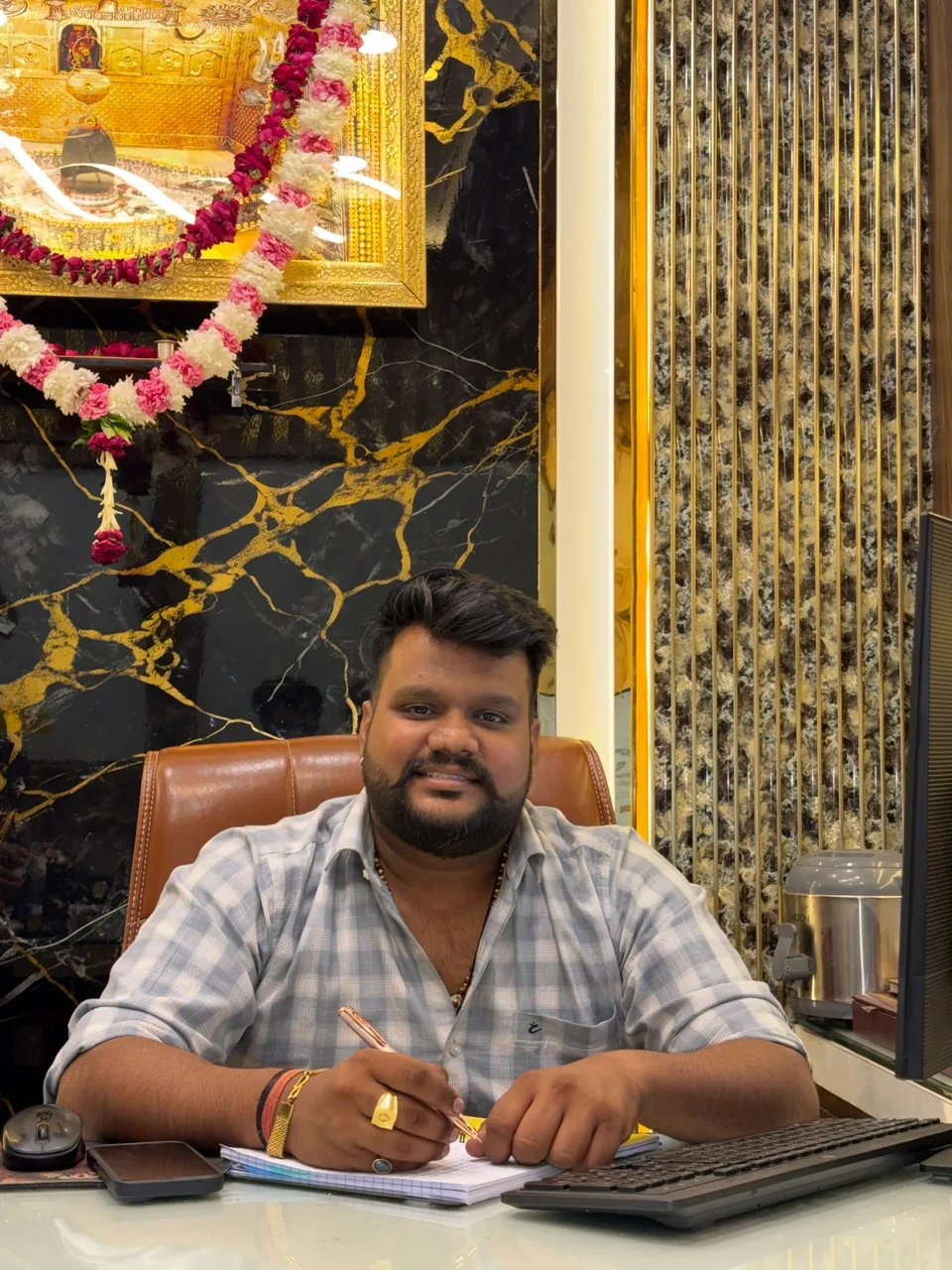 Nikhil Soni, founder of Ecom with Nikhil, seated at his desk.